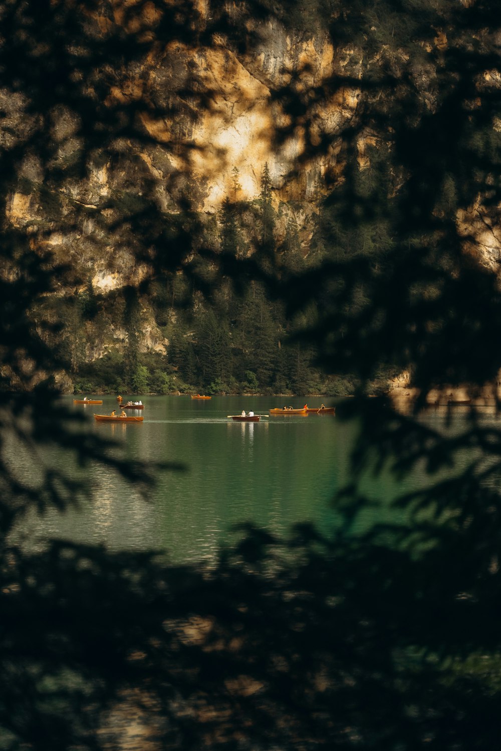 a group of boats floating on top of a lake