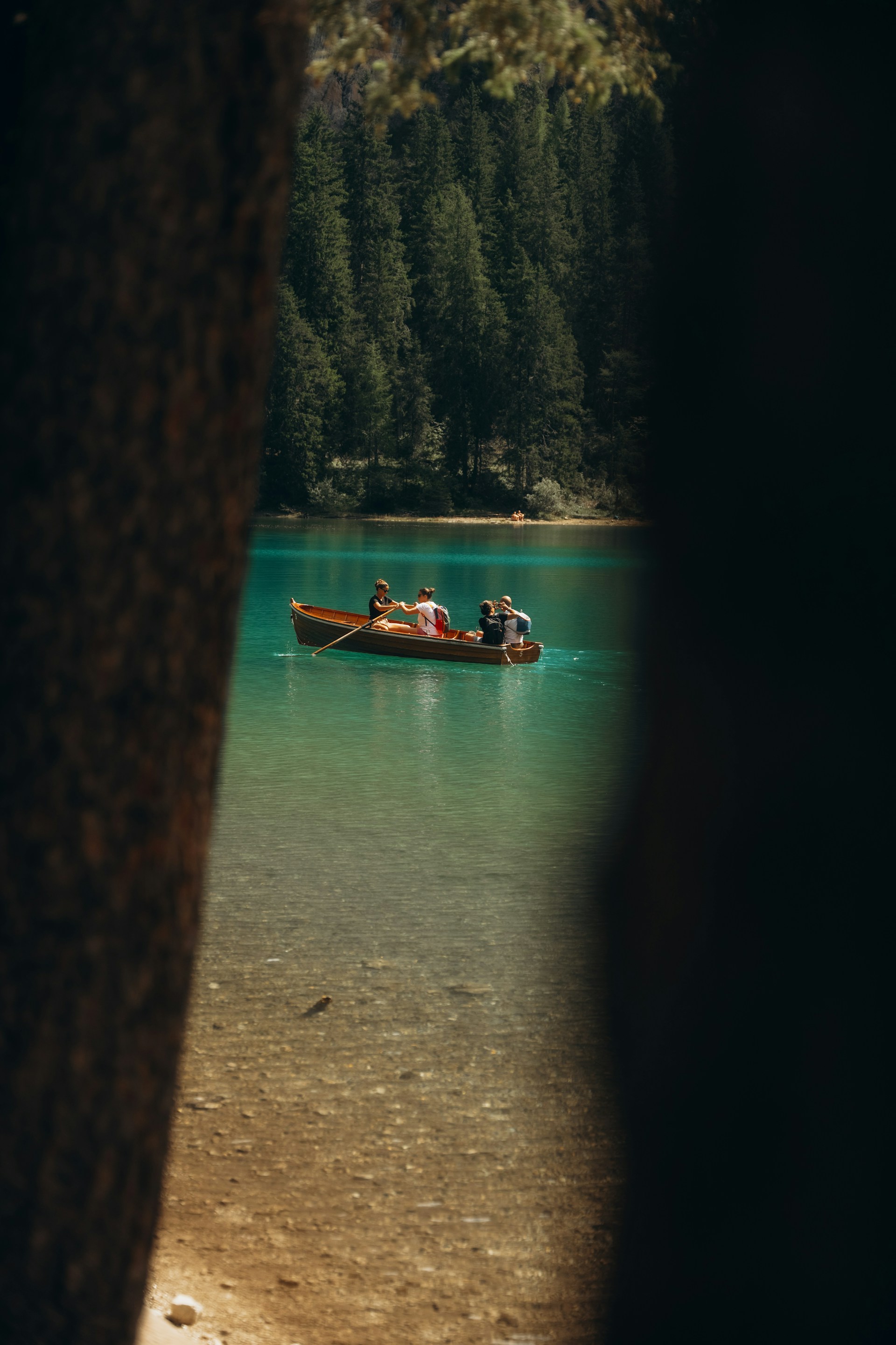 a group of people in a small boat on a lake