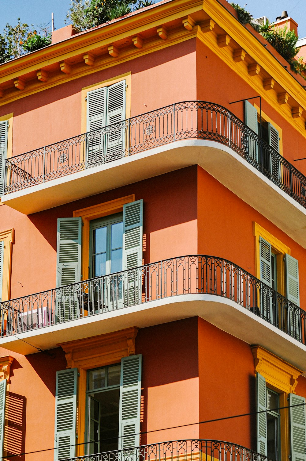 an orange building with balconies and balconies on the balconies