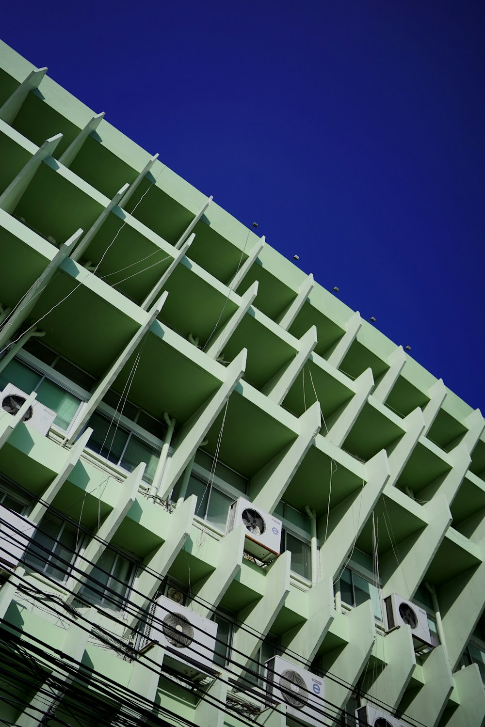 a tall building with lots of balconies on it