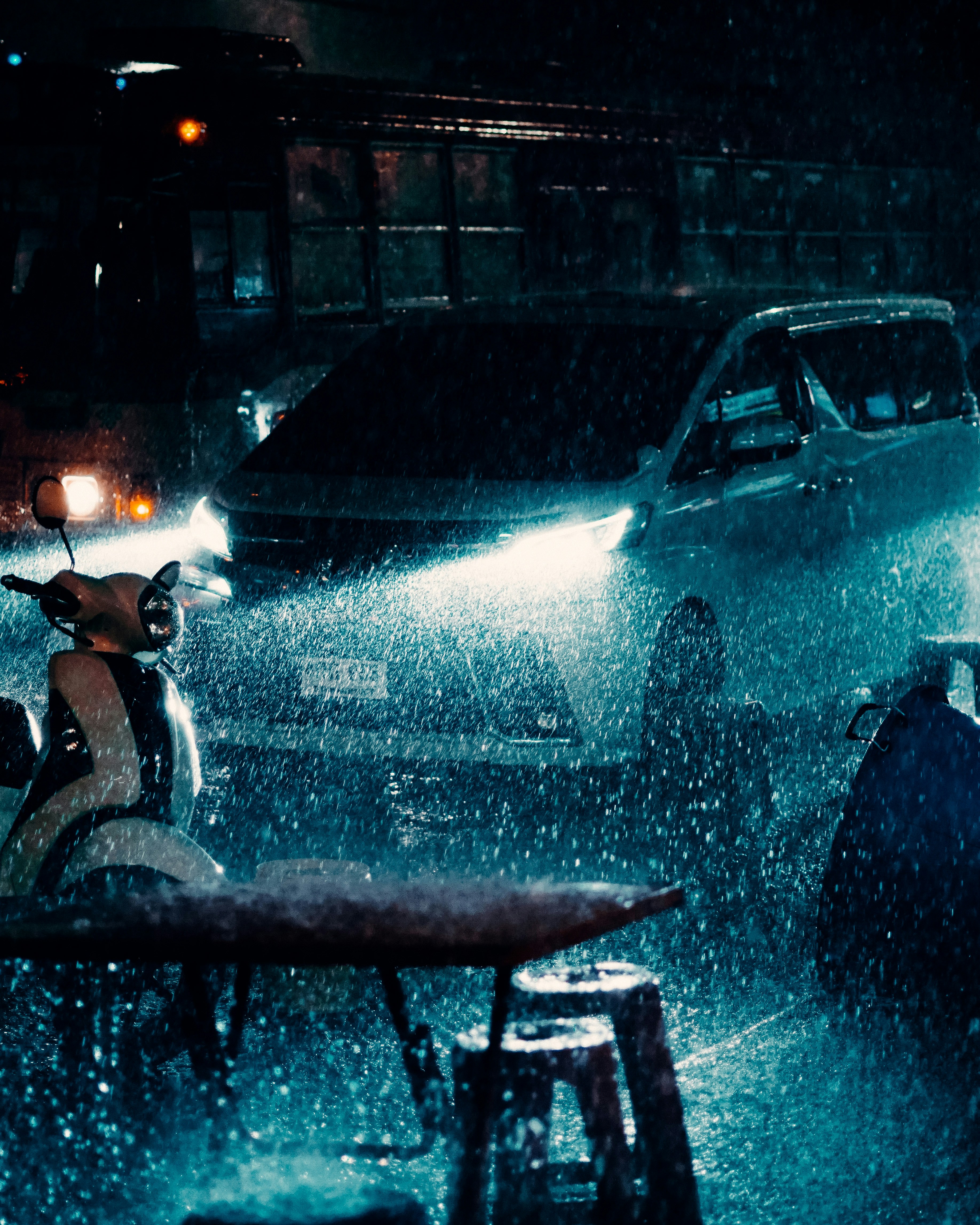 a car driving down a rain soaked street at night