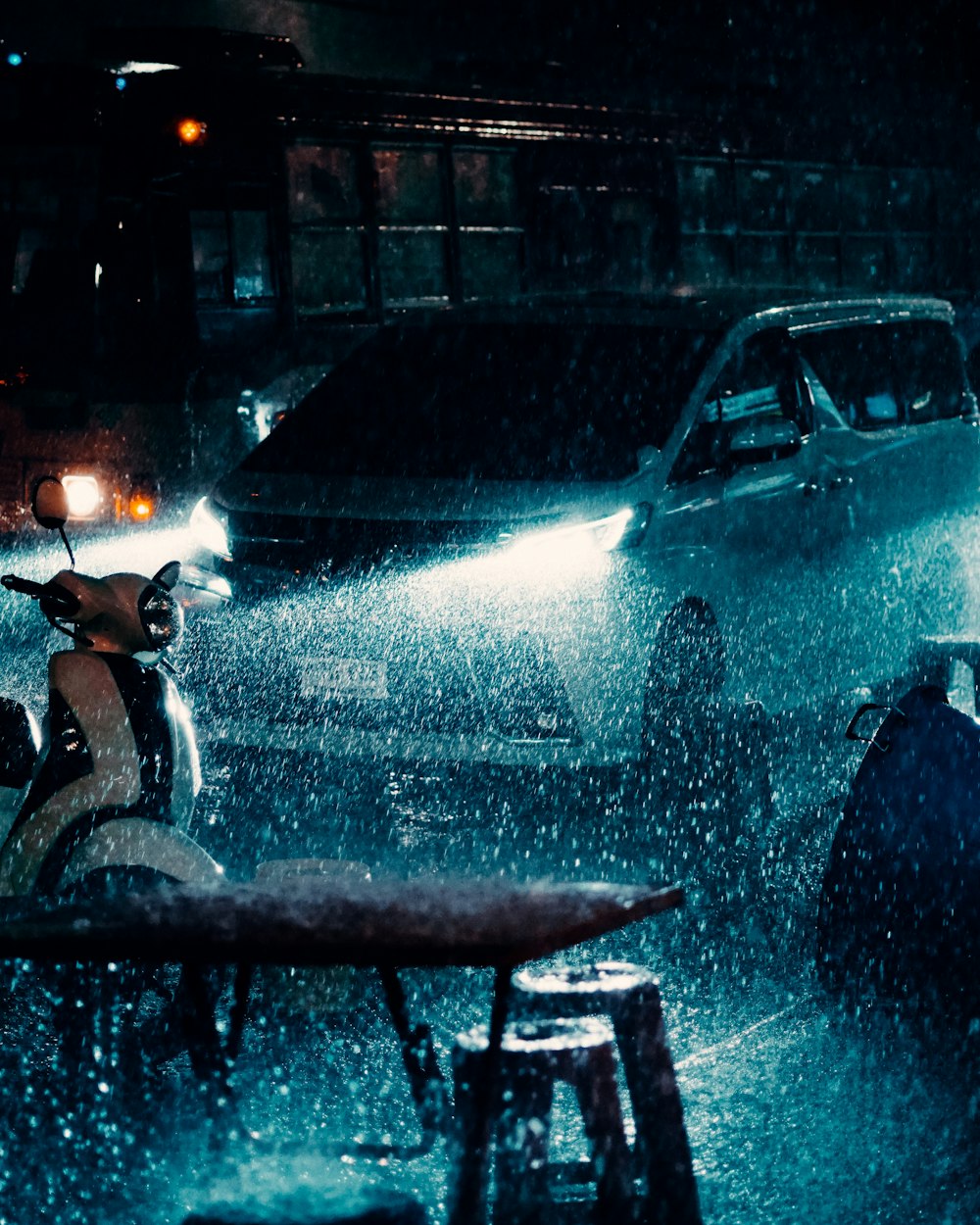 a car driving down a rain soaked street at night