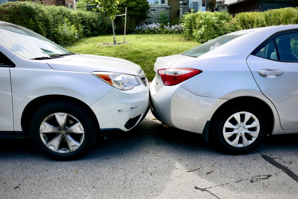 a couple of white cars parked next to each other