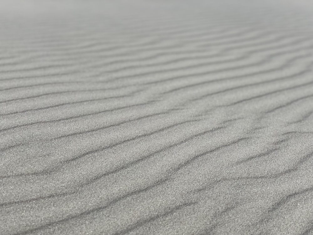 a sand dune with wavy lines in the sand