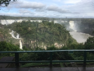 The stunning Iguazu Falls viewed from the Brazilian side with lush greenery.