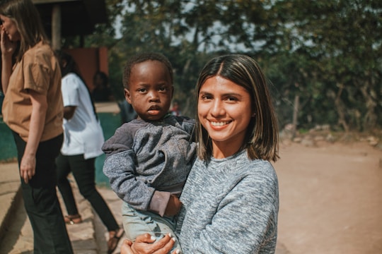 a woman holding a small child in her arms