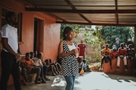 A woman standing before her family, sharing stories about family history she learned from podcasts