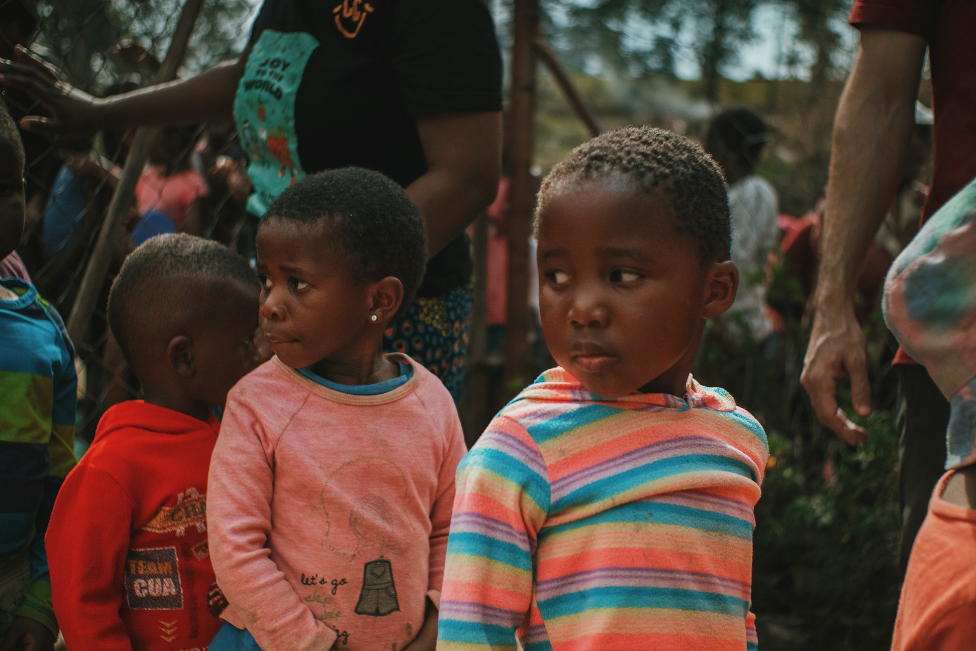 a group of young children standing next to each other