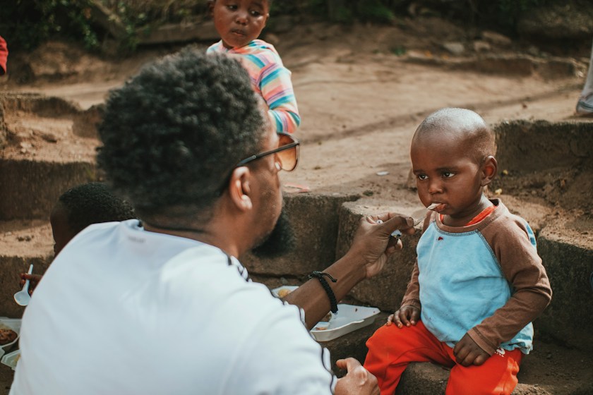 A health worker with a child at a rural health post