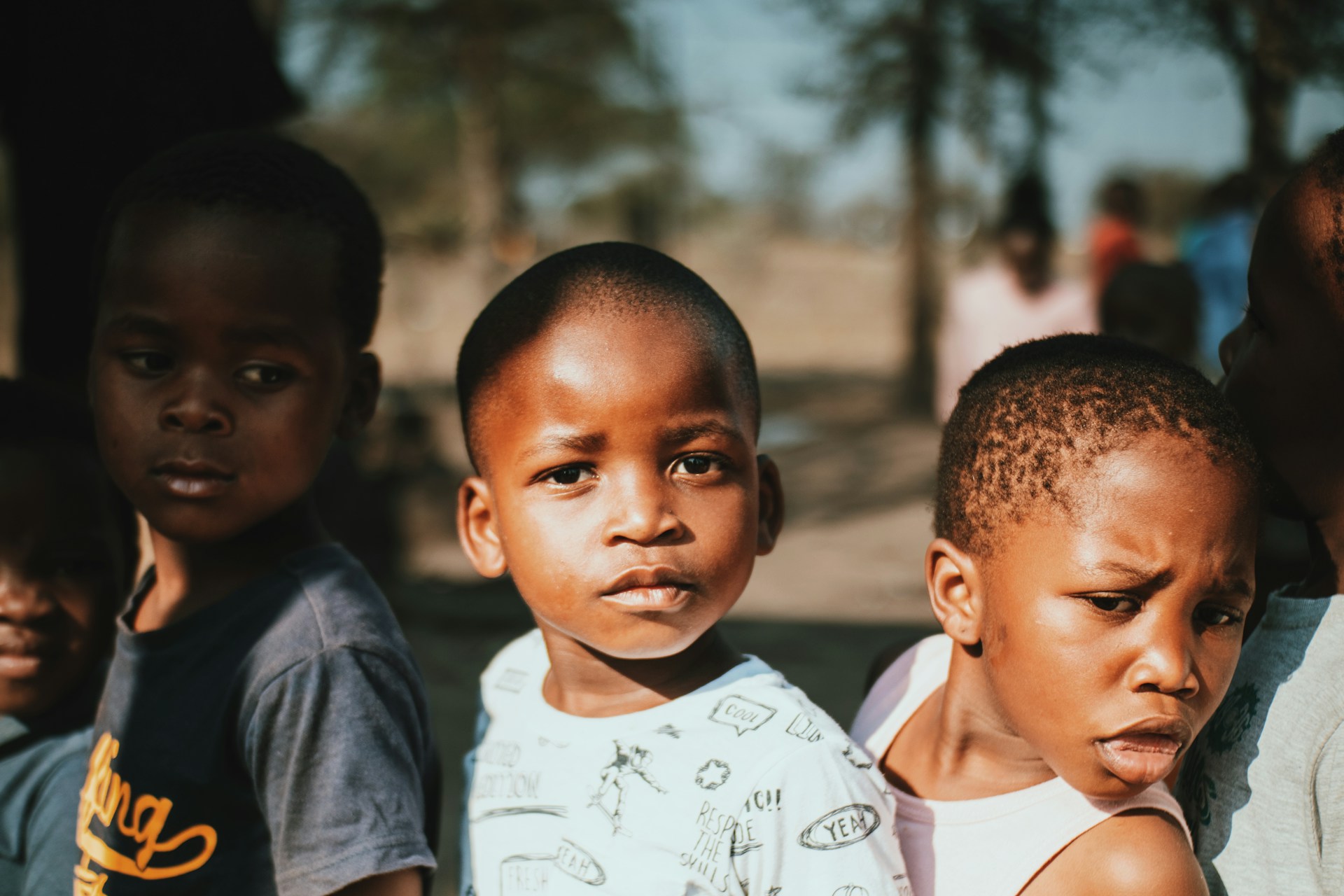 a group of young boys standing next to each other