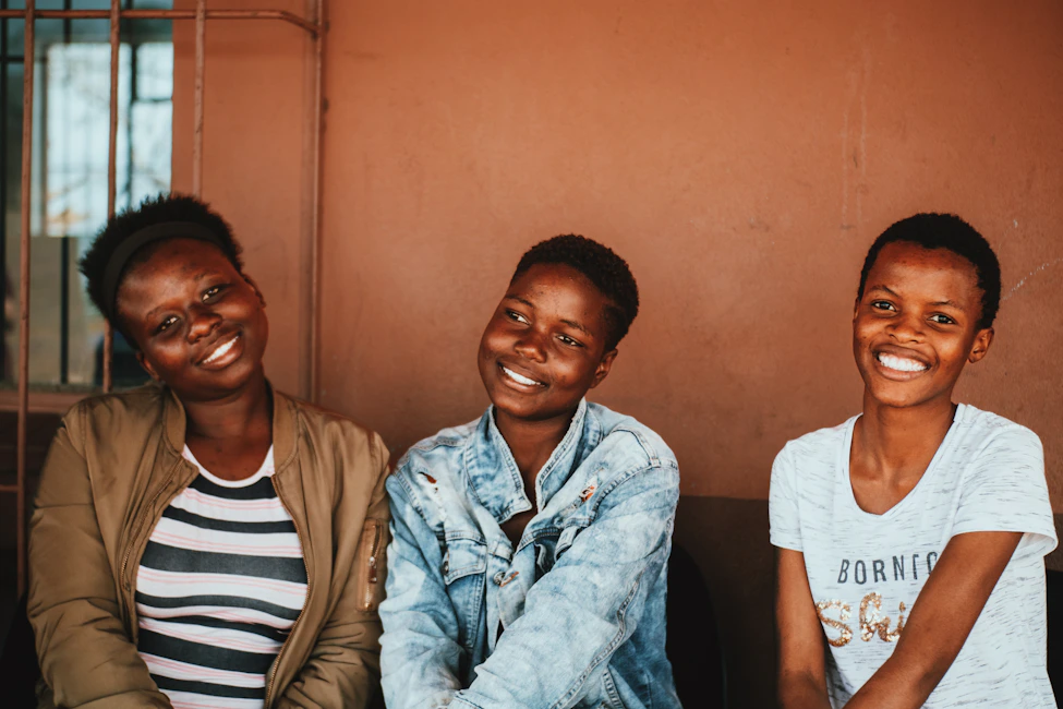 Young African women smiling together at an event