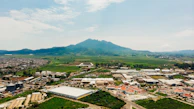 Aerial view of the manufacturing facility surrounded by green fields under a clear sky.