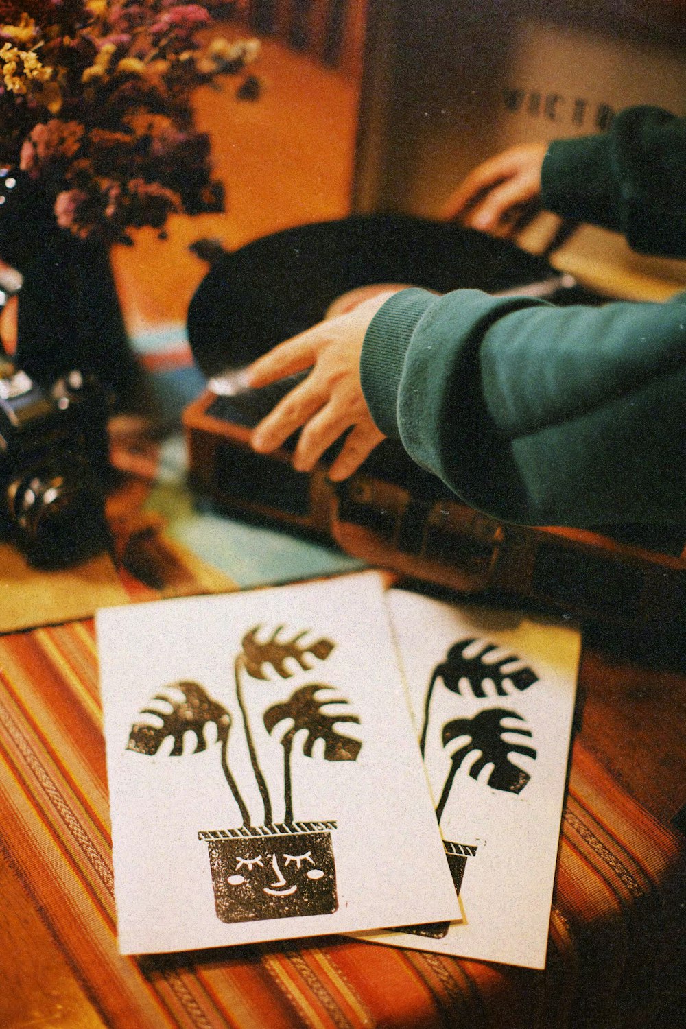 a person using a computer on top of a wooden table