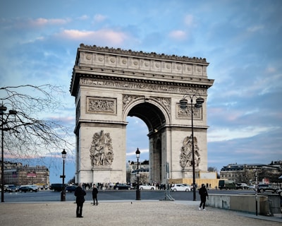 a group of people standing in front of a large arch