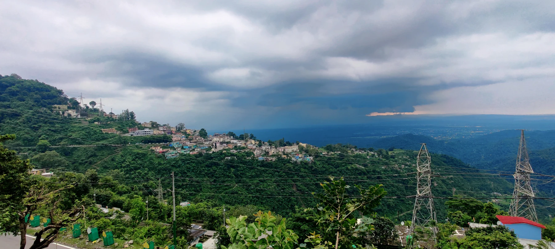 Narendra Nagar on its ridge above the plains, under monsoon cloud