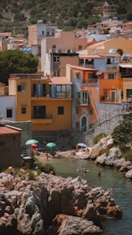 A vibrant shoreline village with bustling shops, a hotel, and people enjoying the seaside atmosphere.