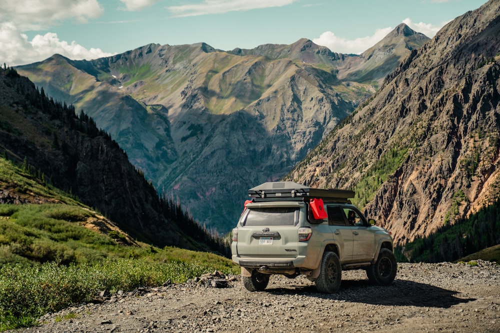 a truck parked on the side of a mountain road