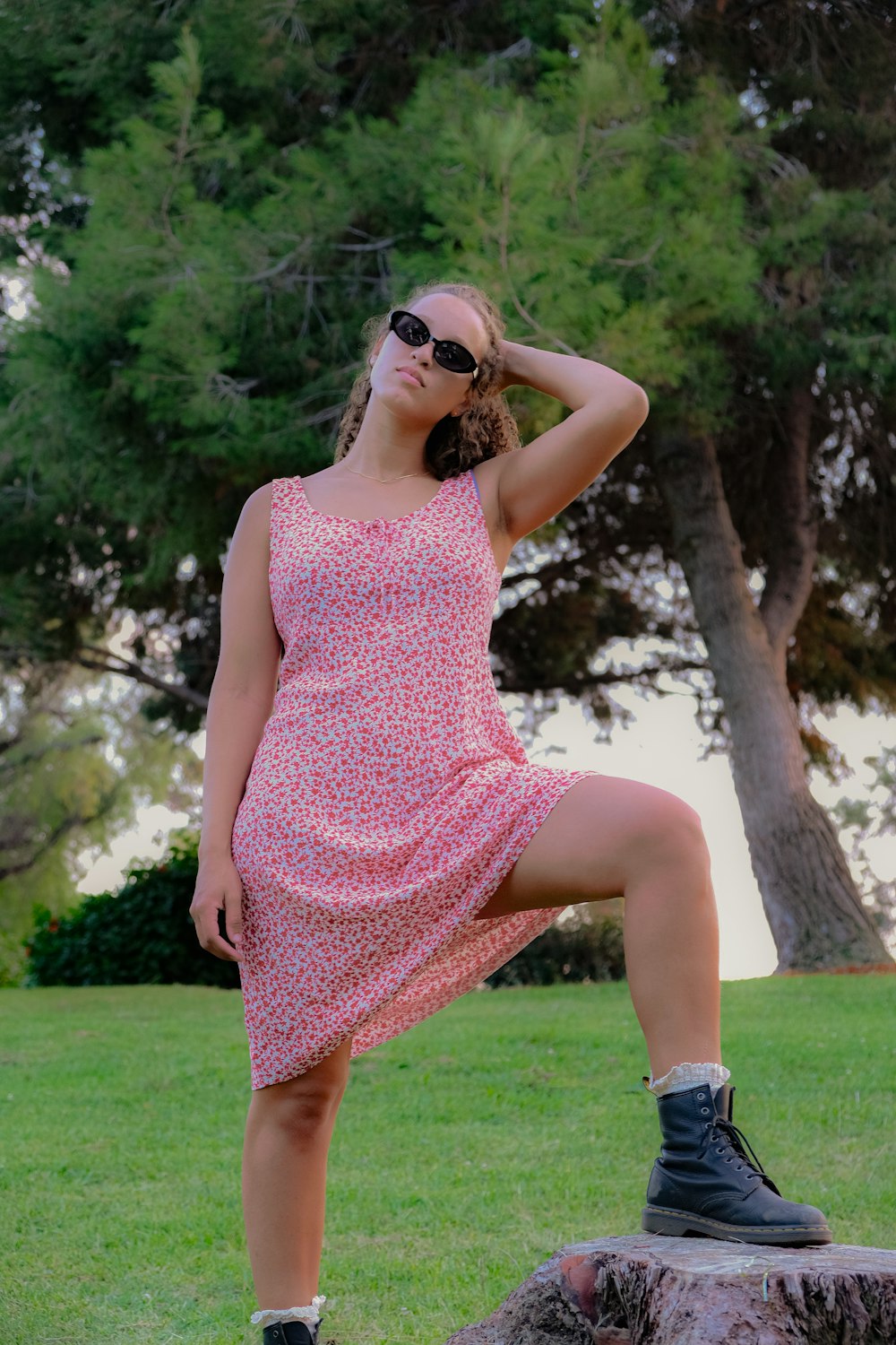 a woman in a pink dress is posing for a picture