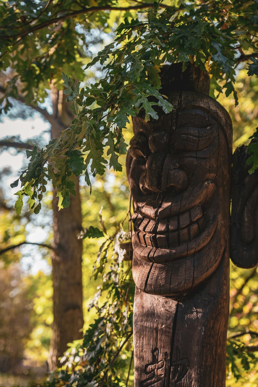 a wooden carving of a man in a forest