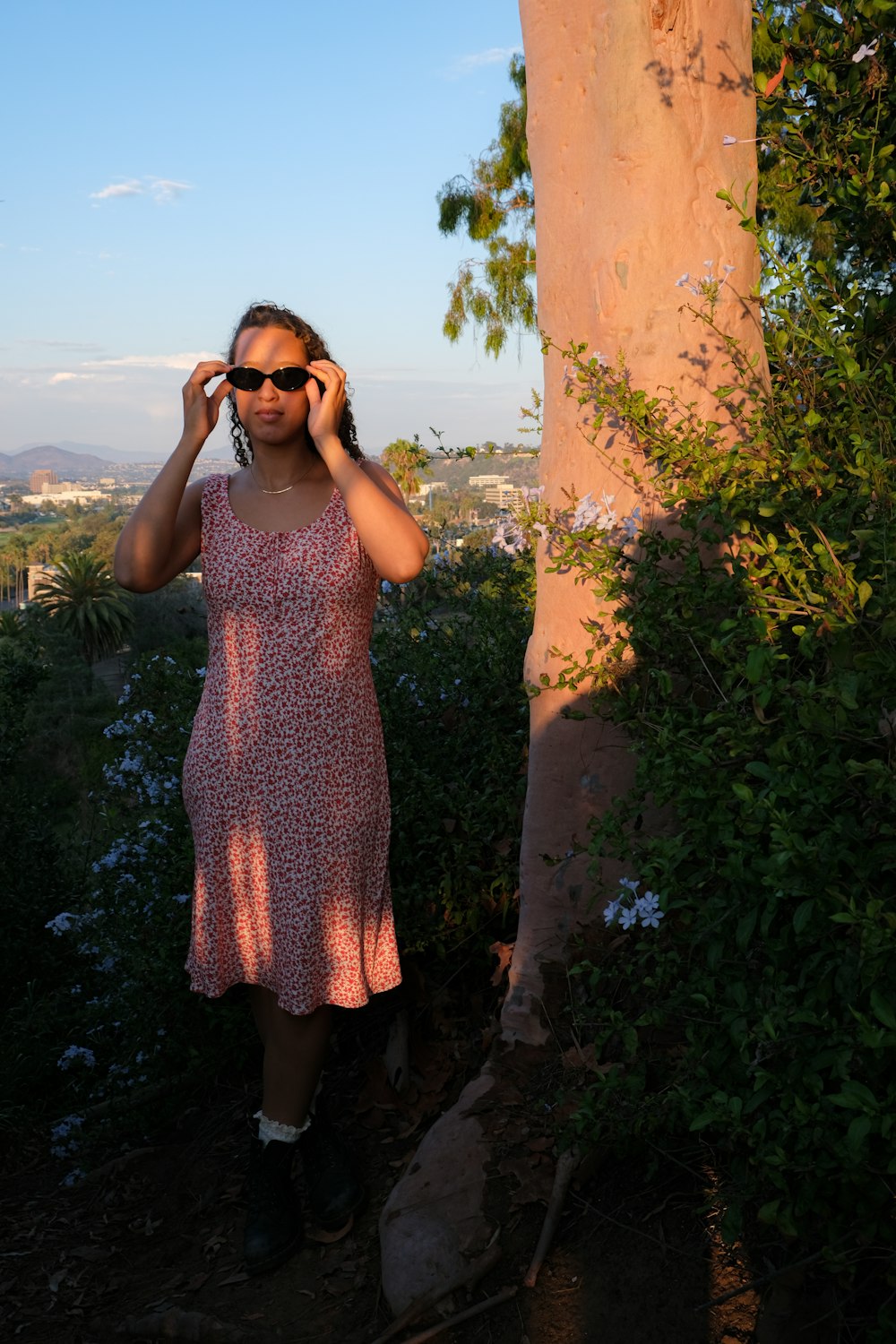 a woman in a dress talking on a cell phone