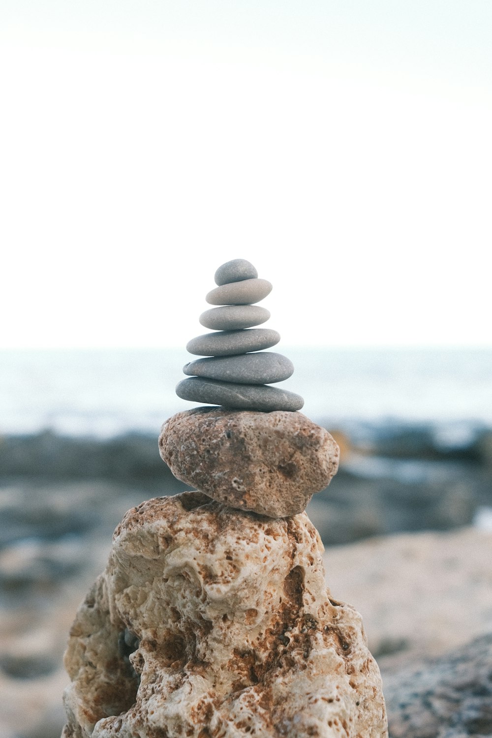 a stack of rocks sitting on top of a beach