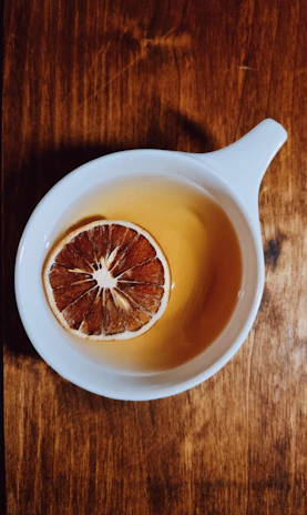 Close-up of a steaming cup of tea with a pat of real butter melting on top, highlighting the rich ingredients.