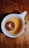 Close-up of a steaming cup of traditional tea on a wooden table.