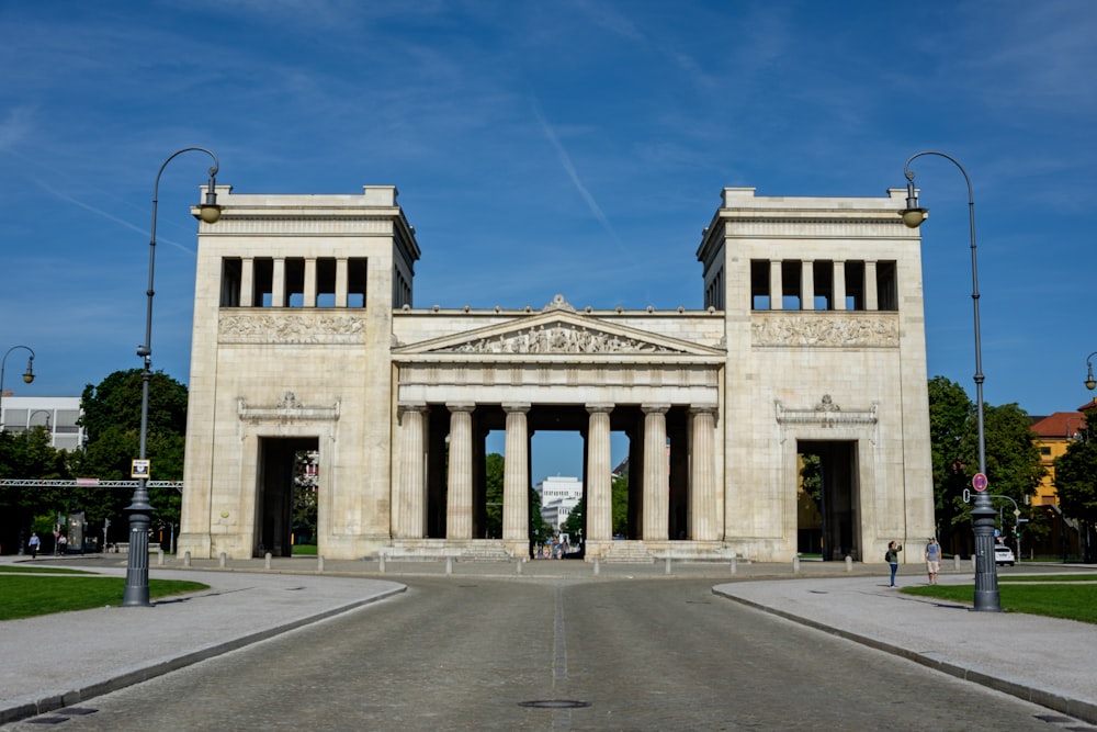 a large white building with two pillars on the front of it