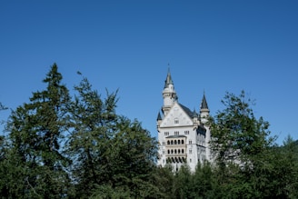 A majestic view of Bishop Auckland Castle standing proudly against a bright sky.