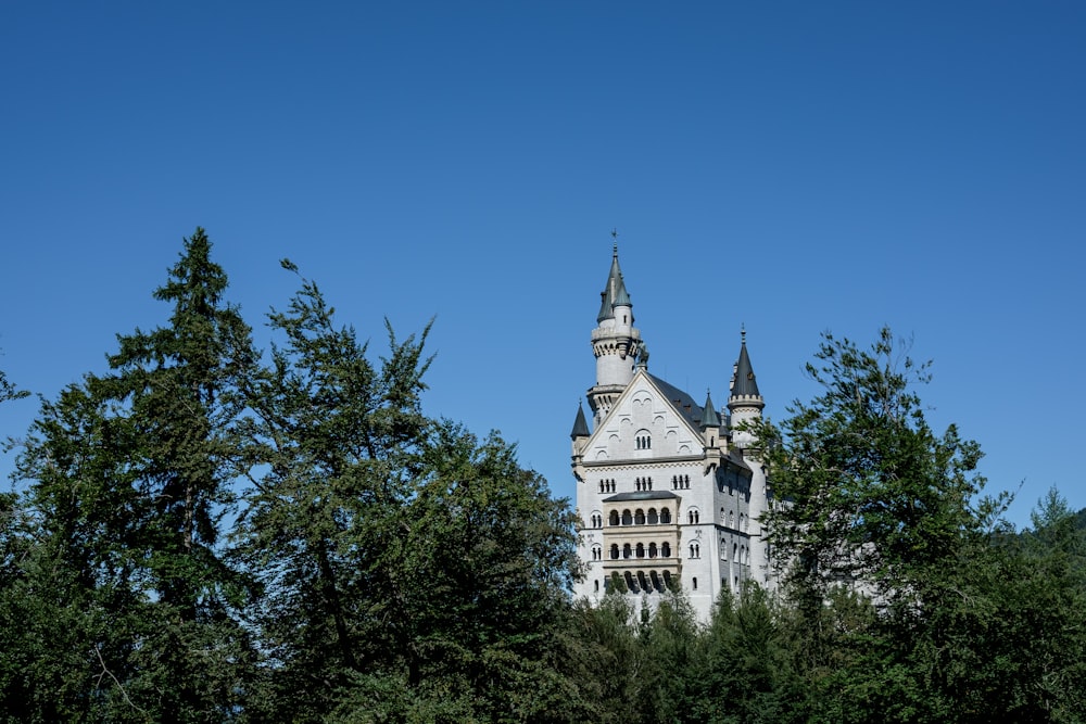 a tall white building with a clock on it's side