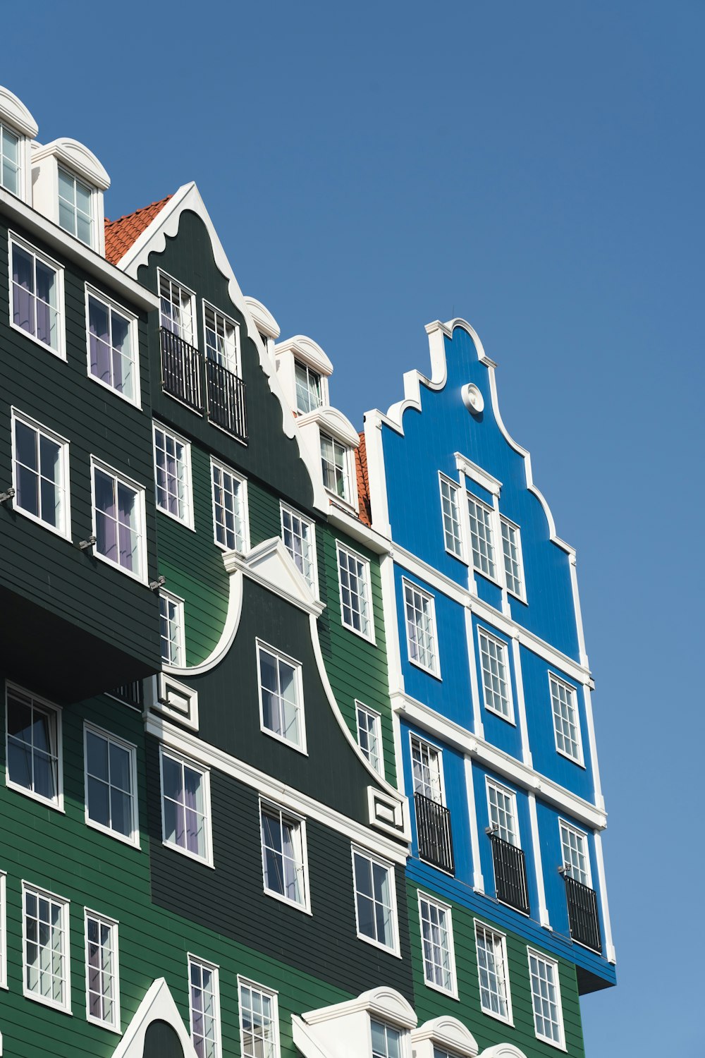 a multi - colored building with many windows and balconies