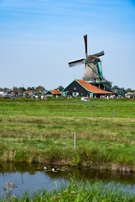 a windmill in the middle of a green field