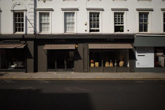 Commercial property storefront with large windows on a busy street in Milan.