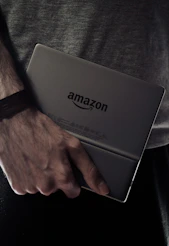 a man holding a laptop computer in his hands