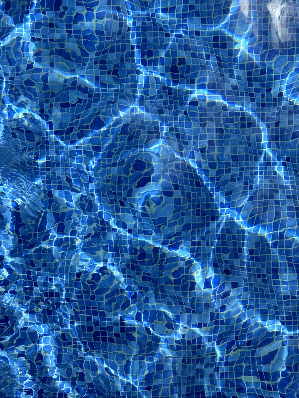 a pool with blue water and rocks in it