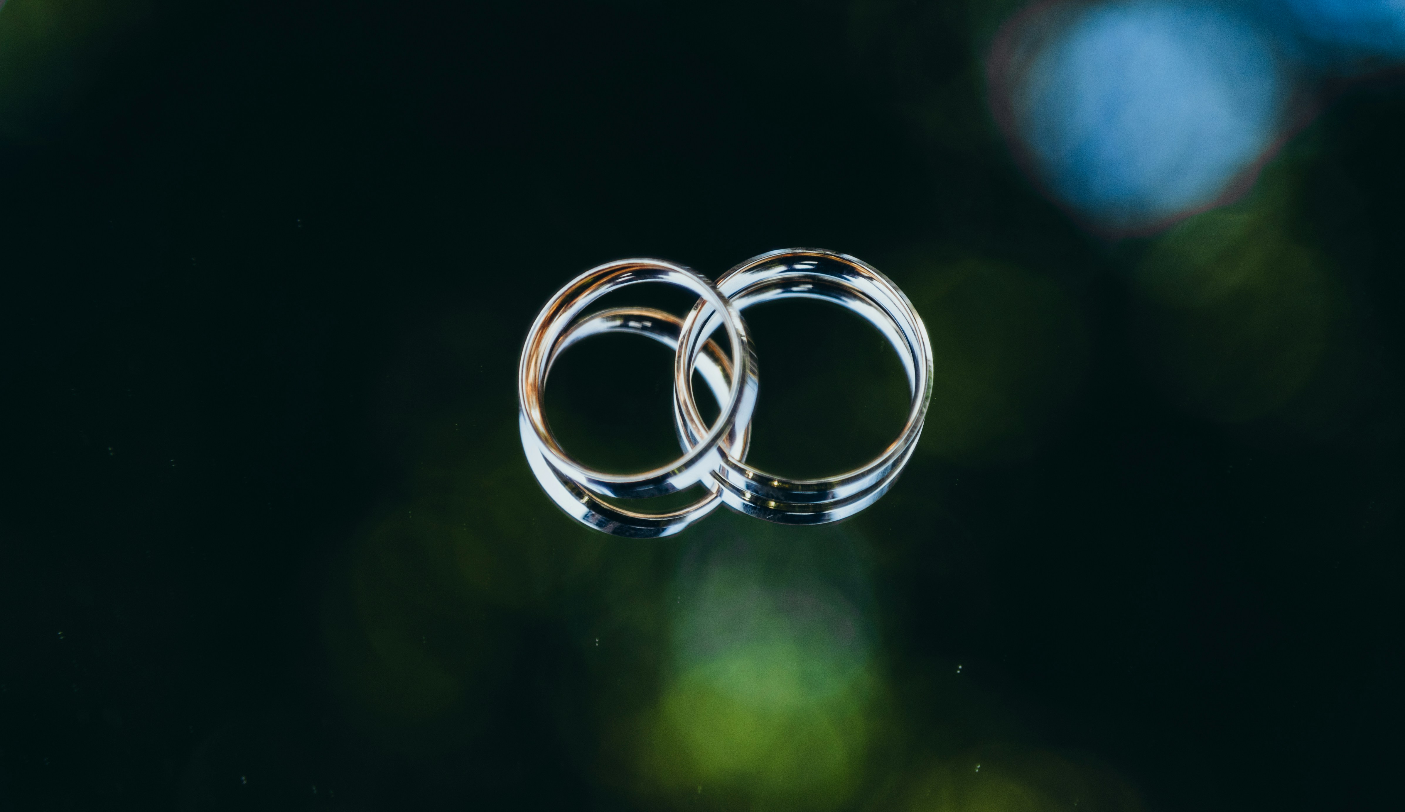 two wedding rings sitting on top of each other