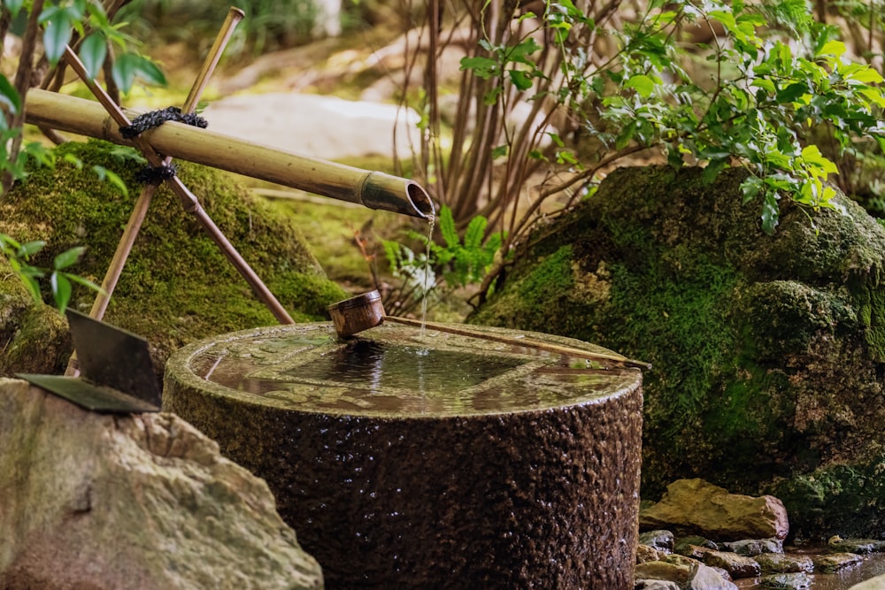 a water well with a wooden spigot on top of it