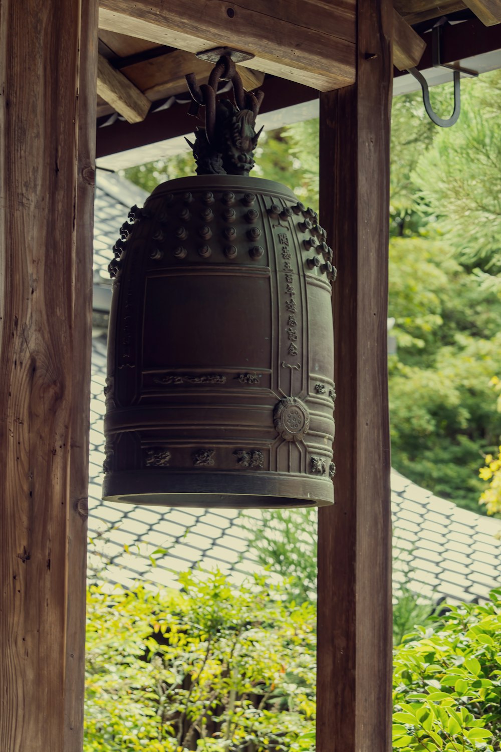 a large bell hanging from a wooden structure
