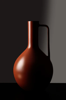 Close-up of a sand-colored ceramic vessel with raw, textured surface and minimalist form.