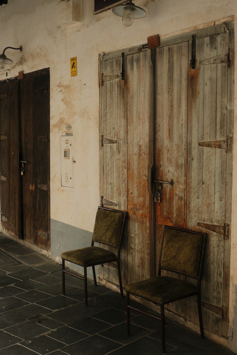 a couple of chairs that are sitting in front of a building