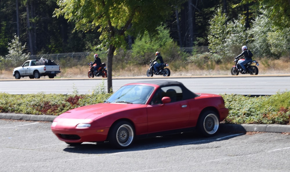 a red sports car parked in a parking lot