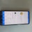 A smartphone lying on a surface with its screen displaying an air quality monitoring app. The app shows various air quality measurements in detail, including PM10, PM2.5, PM1 levels, and temperature. It also indicates that the current air quality index (CAQI) is 73 with a status of 'average'.