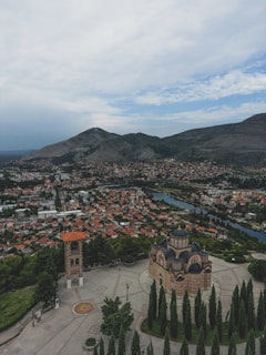 an aerial view of a city with mountains in the background