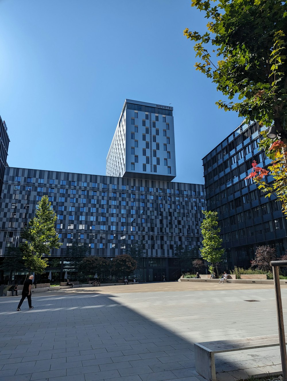 a person walking in front of a large building