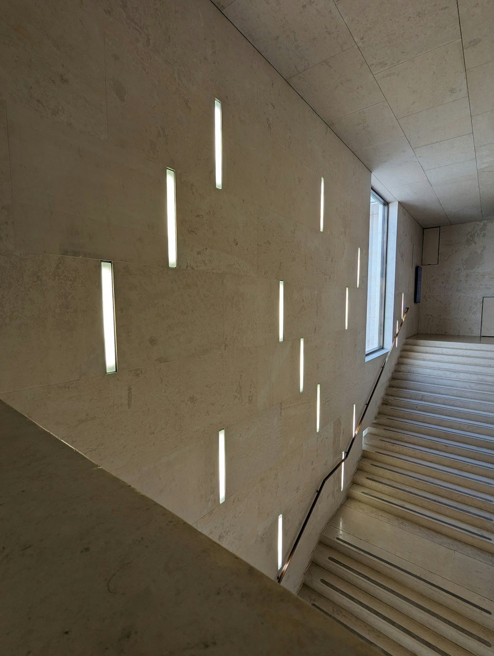 a staircase with lights on the side of it