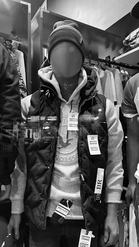 A stylish mannequin dressed in layered outfits showcasing casual and chic looks.