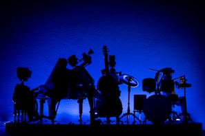 An artistic representation of musical instruments in shadowy tones.