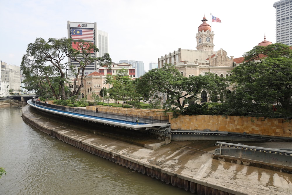 a river running through a city next to tall buildings