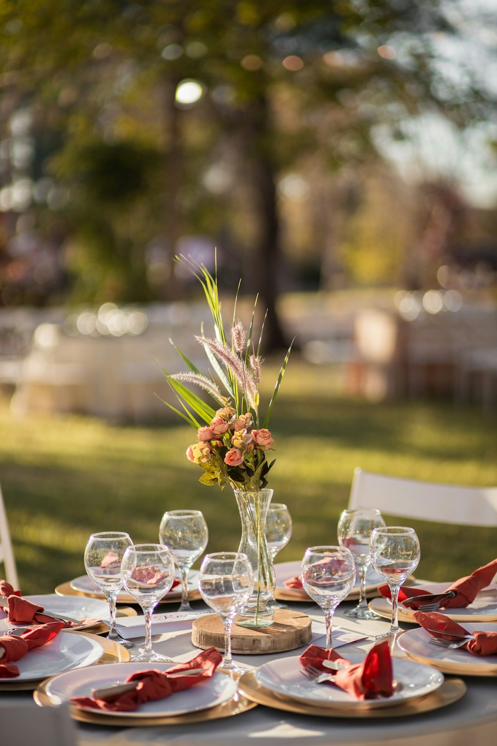 a table set for a formal dinner outside