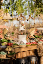 a table topped with a white cake covered in flowers